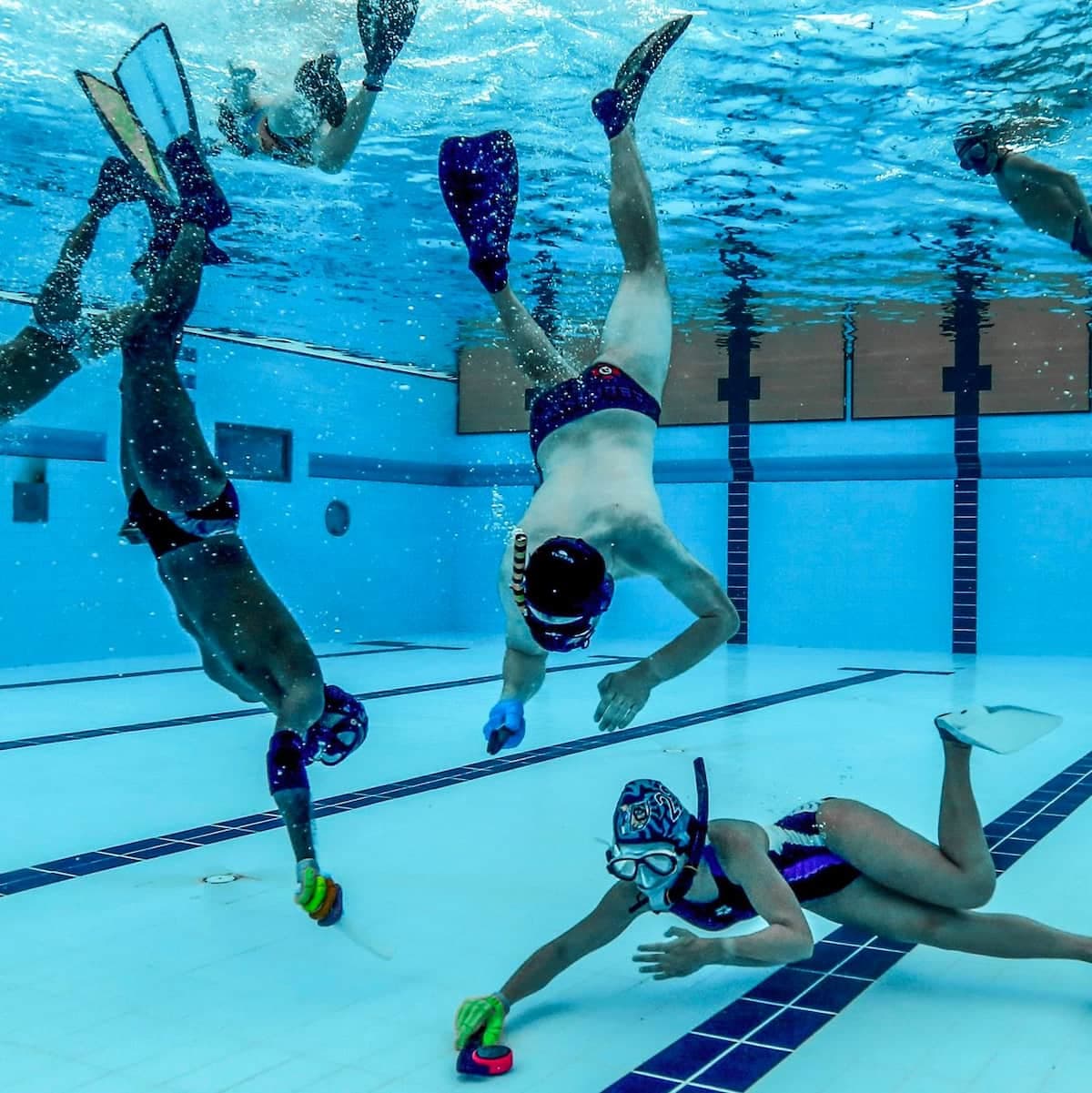 Underwater hockey players in action